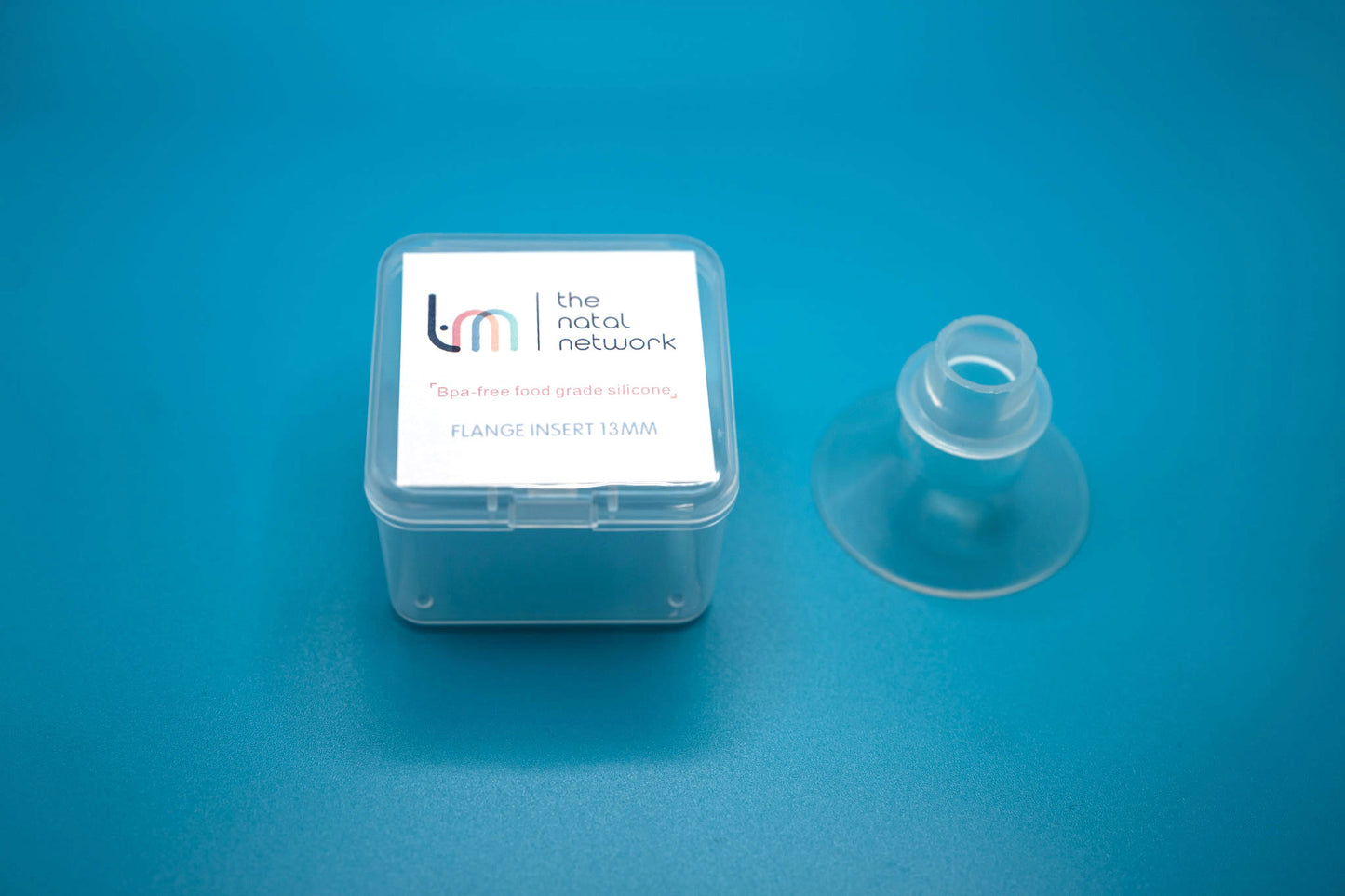 Breast pump flandge in a Natal Network box, on a blue background. 