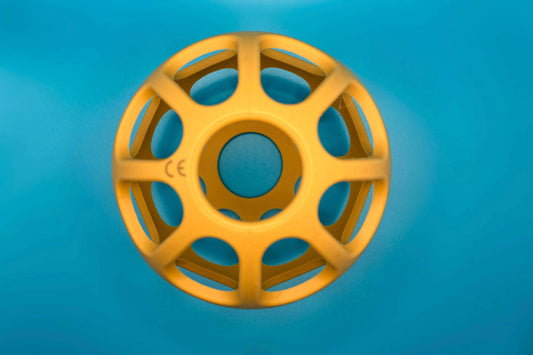 Yellow round teether on a blue background